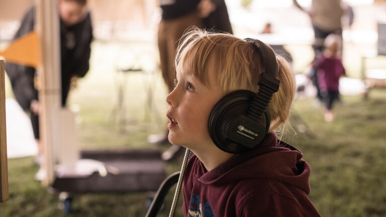 Visitor using MKII Headphones at the Auckland War Memorial Museum 768x432