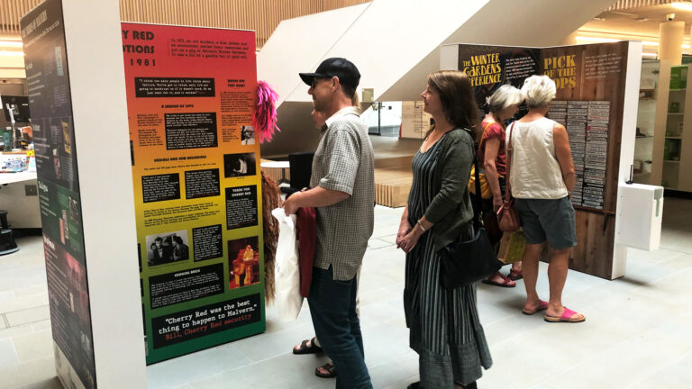Visitors interacting with information panels 768x432