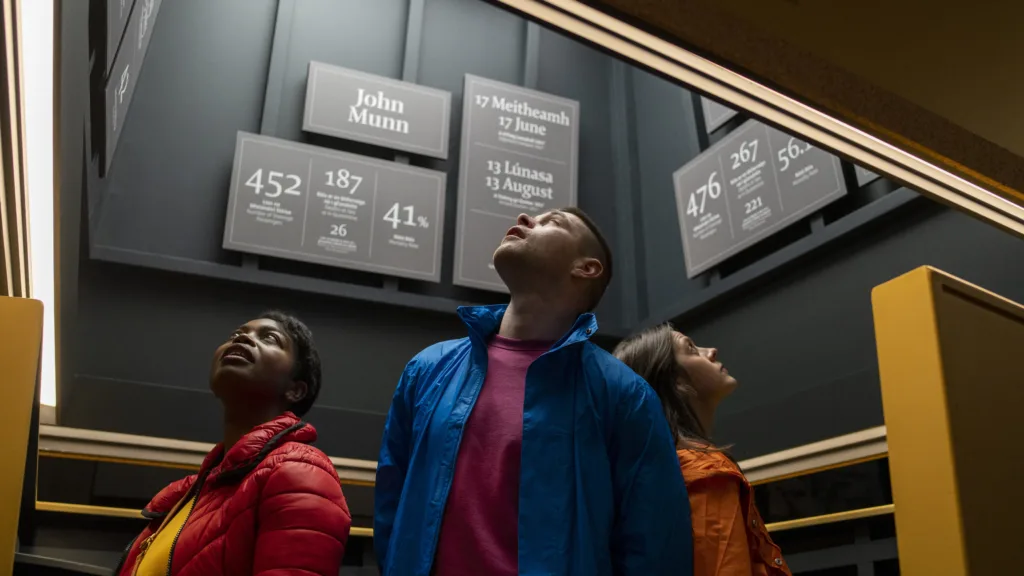 Visitors observing historical display panels.